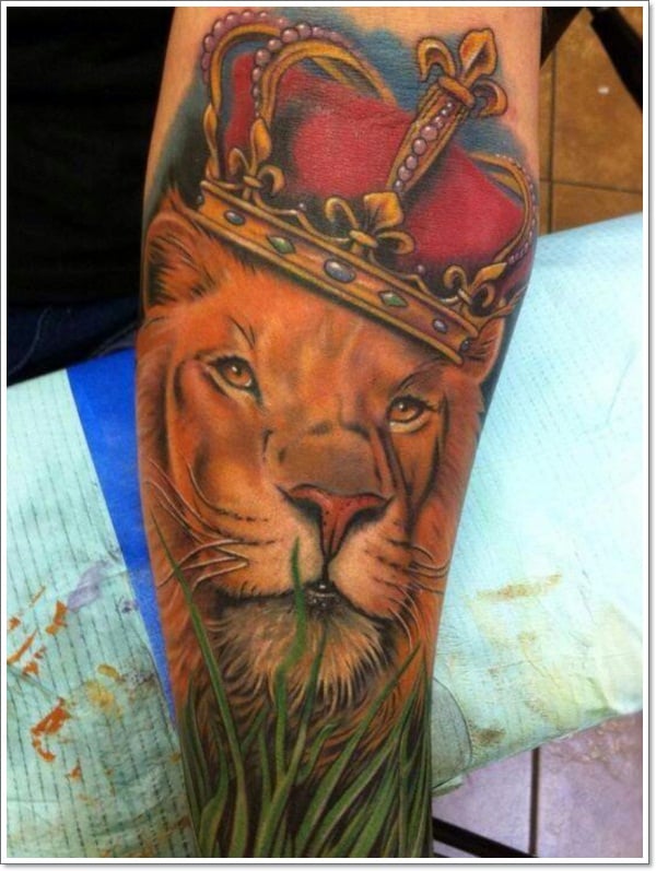 This-lion-tattoo adds-to-the-royal-sense-of-lions-by-including-a-jeweled crown-in-the-style
