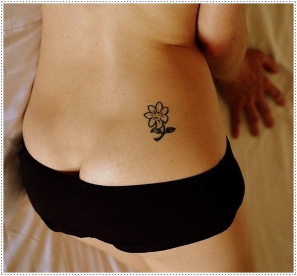 small-flower-tattoo-on-girl-lower back
