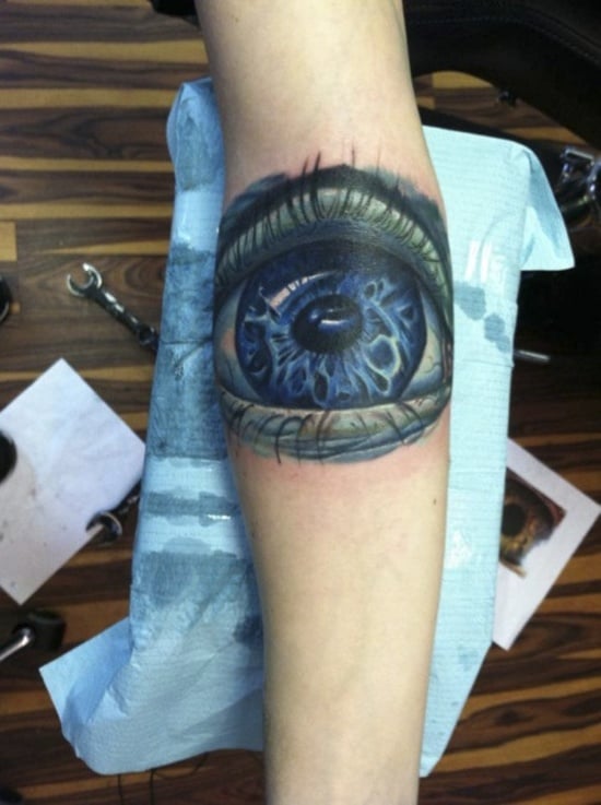 Ornamental hands and evil eye tattoo on the wrist some